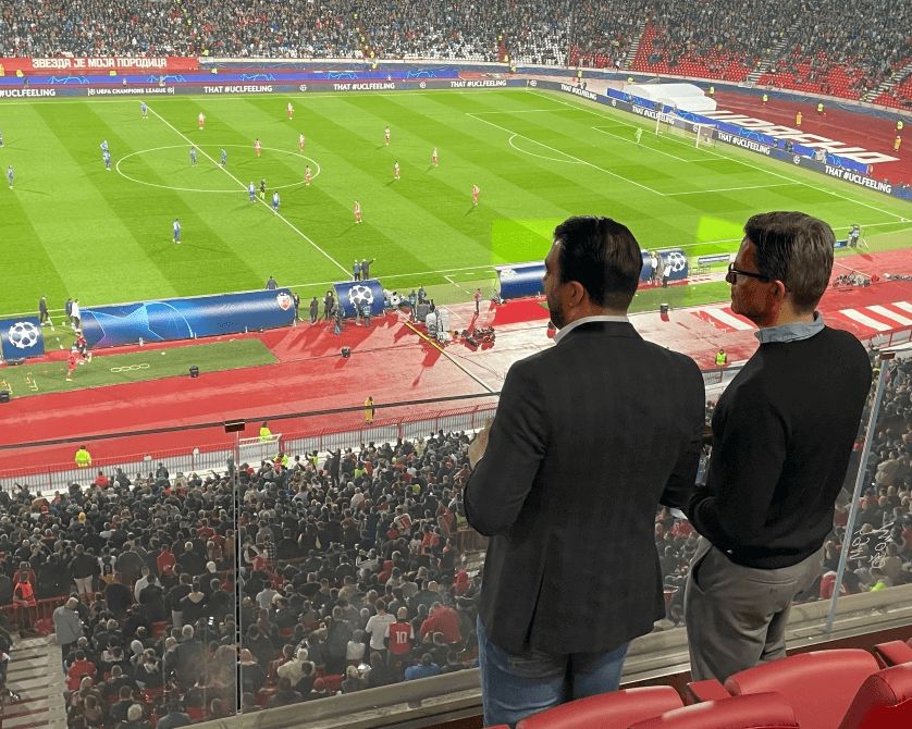 Two Data Talks team members watching a Red Star game